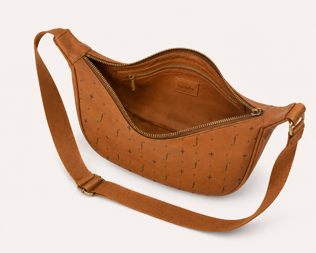 Tan leather sling bag open showing interior