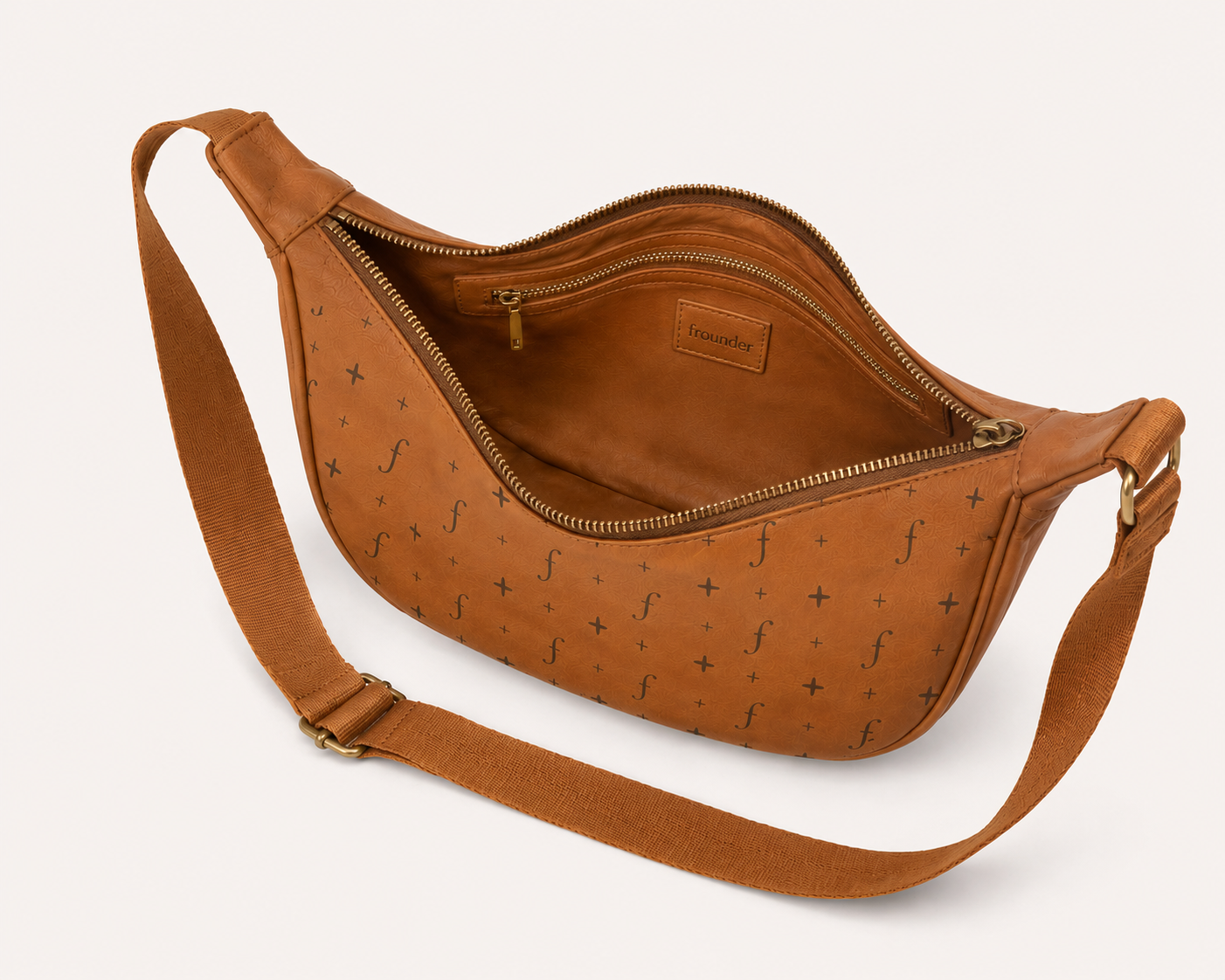Tan leather sling bag open showing interior